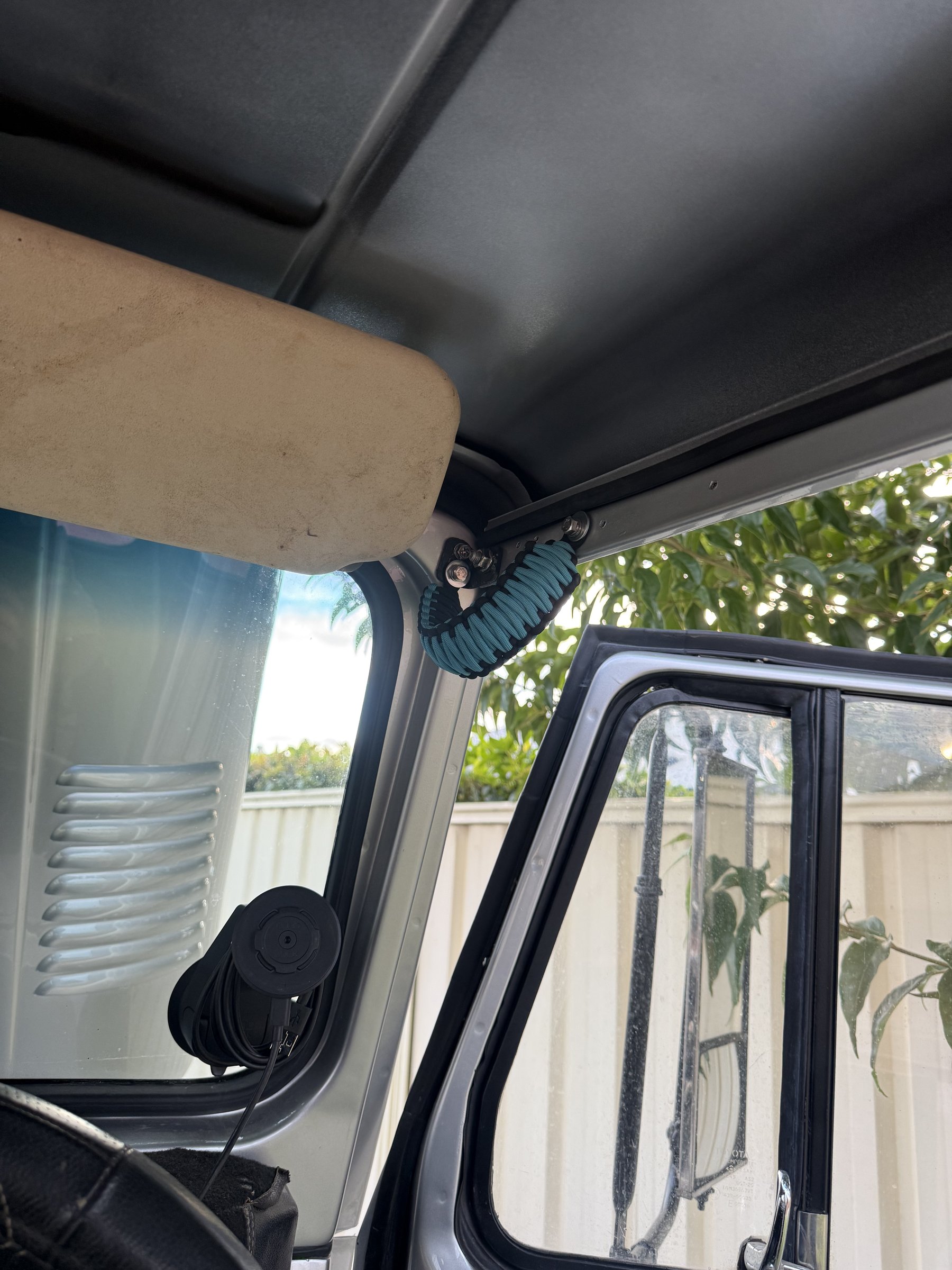 Interior detail — paracord grab handle above the visor