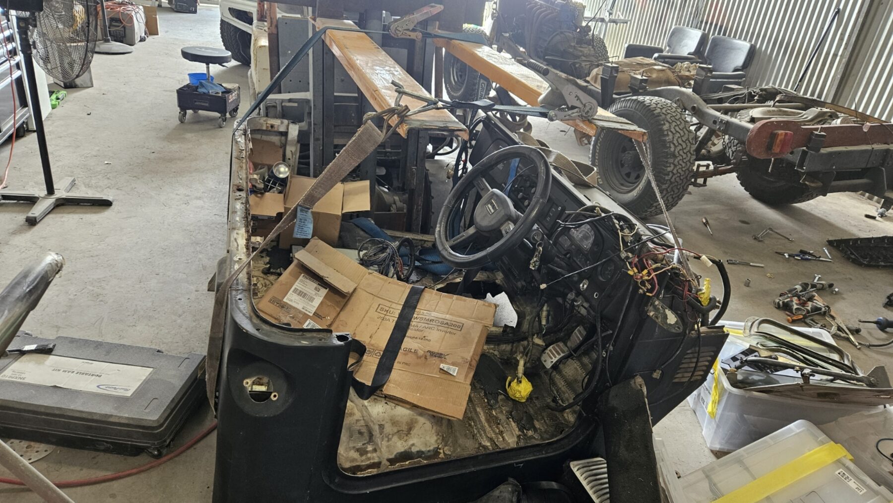 Cab lifted showing interior and floor pans