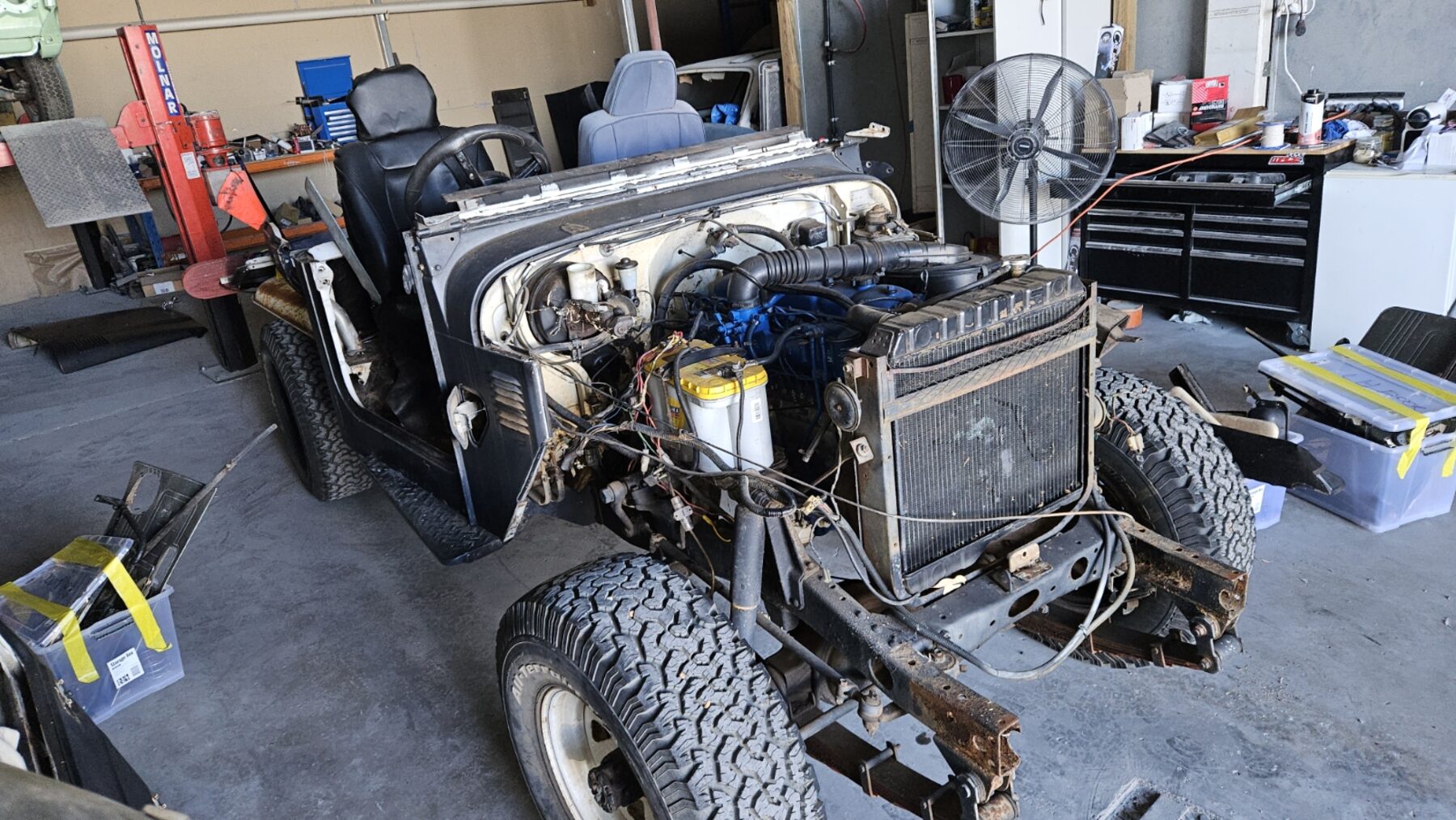 Engine bay during teardown showing the rebuilt blue 2H