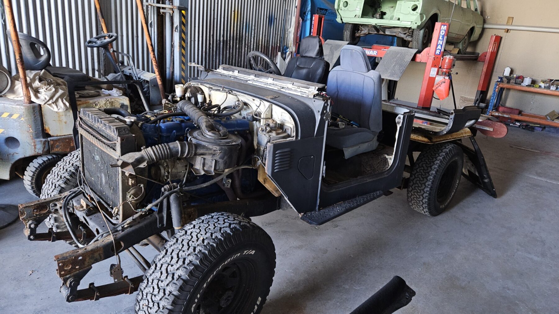 Cab and chassis with drivetrain exposed